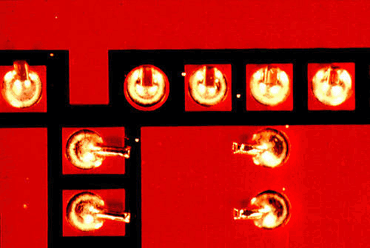 Figure 5: Solder balls on this board were caused by spitting from the surface of the wave
